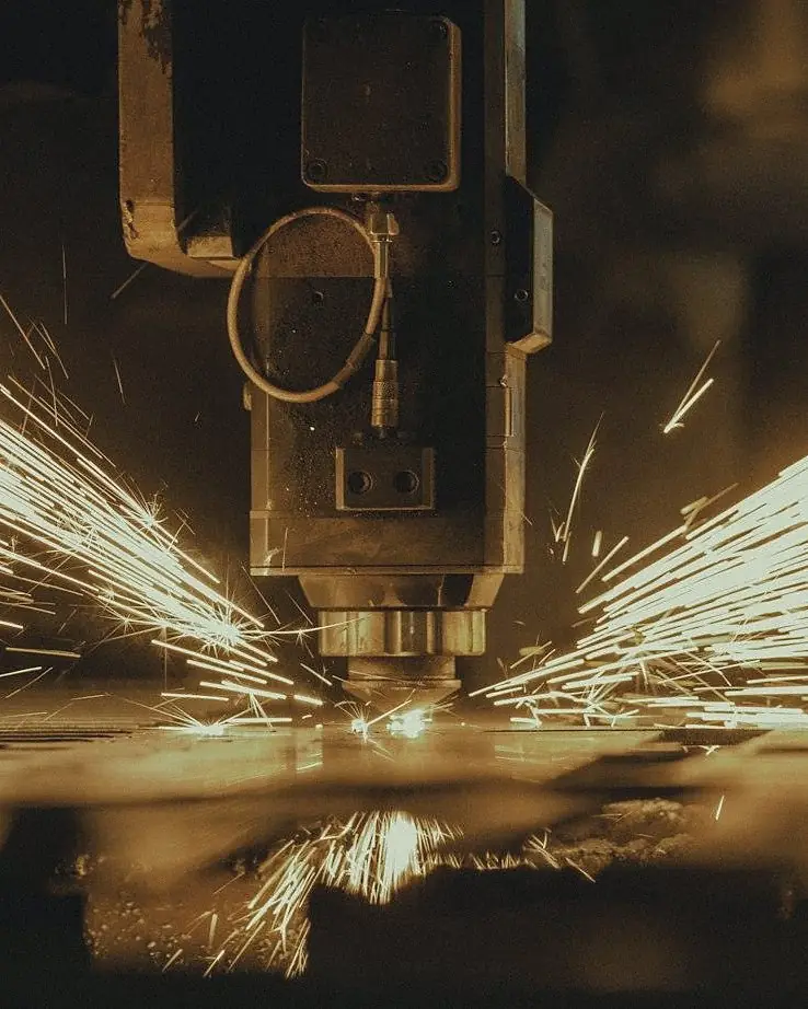 Fiber laser head cutting steel with sparks